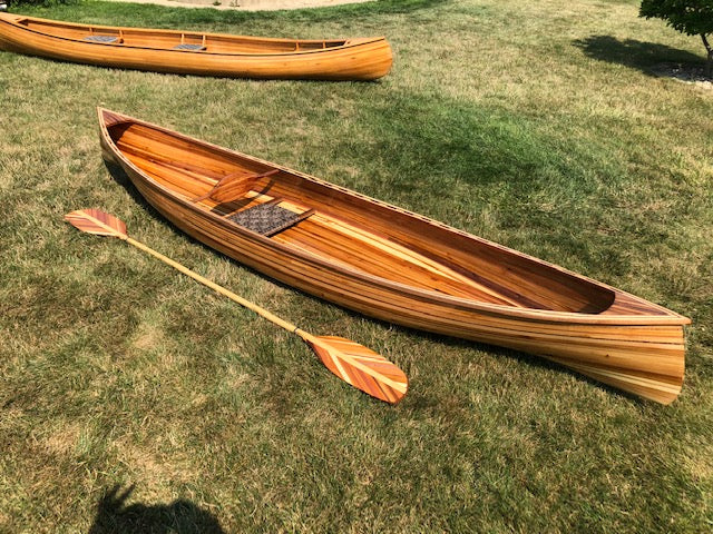 Large cedar strip canoe with cedar oars. Beautiful cedar wood covered with fiberglass and resin.