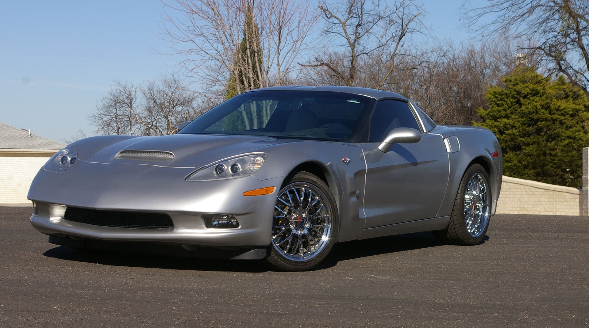 Silver 2006 Chevy corvette customized with fiberglass and resin.
