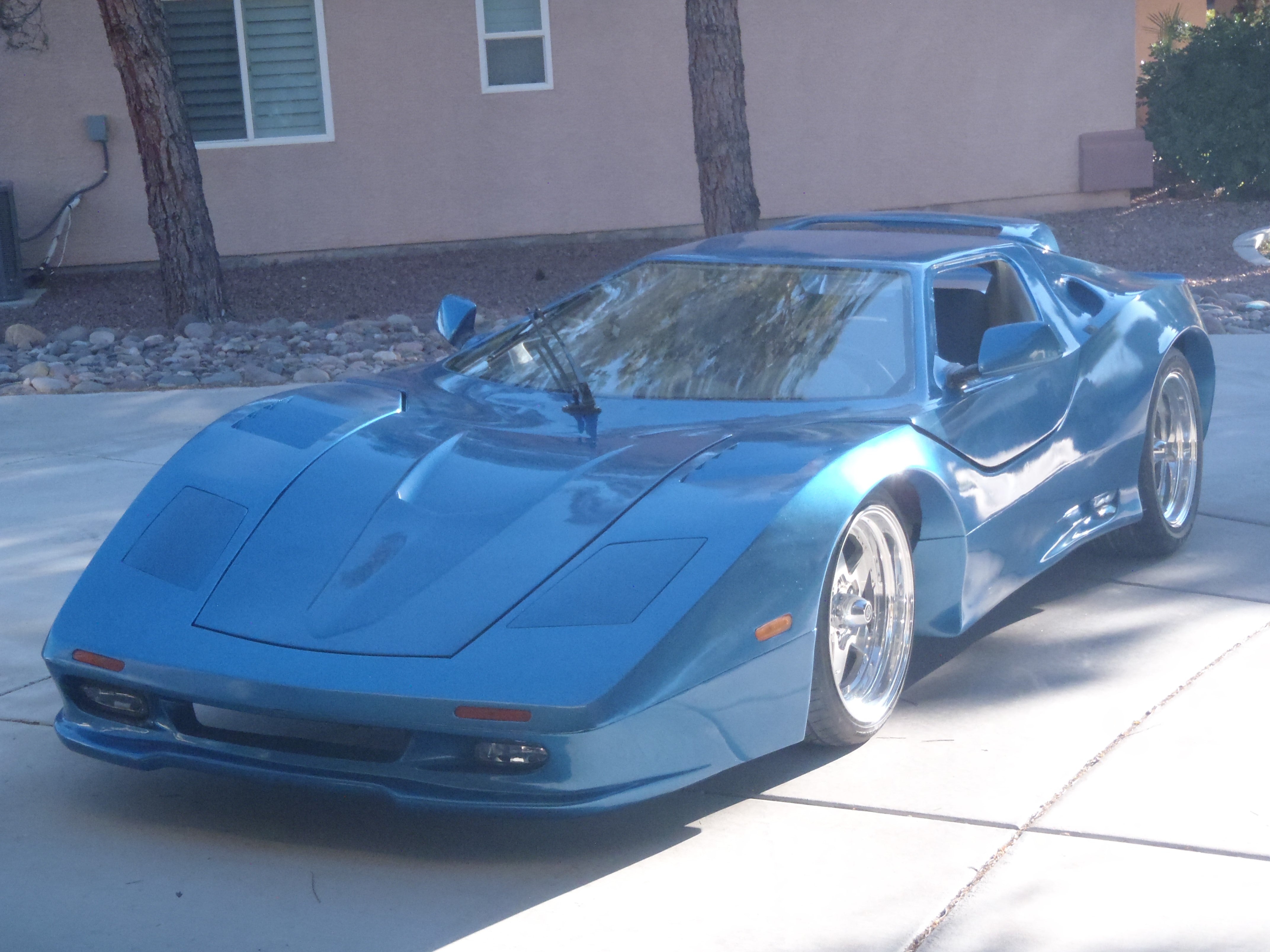 Blue modified corvette with fiberglass and resin.
