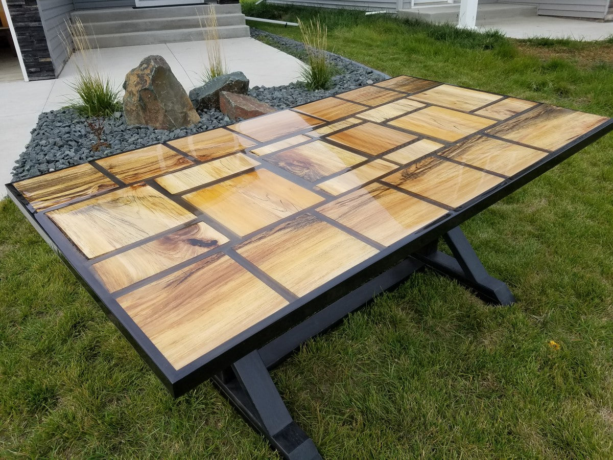 Beautiful wood grain patchwork table top with table top epoxy resin clear coat.