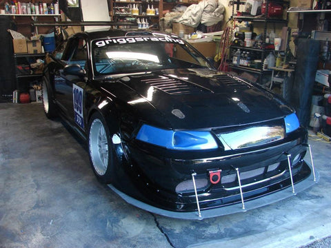 Car fender and splitter made using a fiberglass mold. Made with fiberglass, carbon fiber, resin and gel coat.
