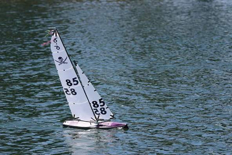 Fiberglass RC boat on water. Made with 4 ounce fiberglass cloth, 3/4 ounce fiberglass, epoxy resin, glass bubbles and fumed silica.