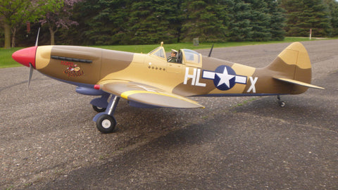 Giant Scale Phoenix Spitfire RC plane created with fiberglass and resin and painted with brown, yellow, red and navy blue.