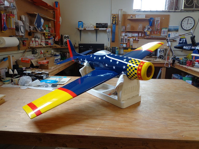 Navy, yellow and red RC fiberglass plane with stars and checkerboard print.