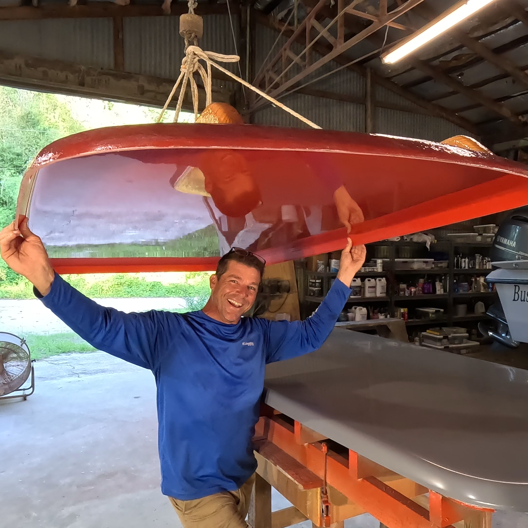 Captain Joe with Fish Bump TV holding a recently parted red mold in a workshop setting